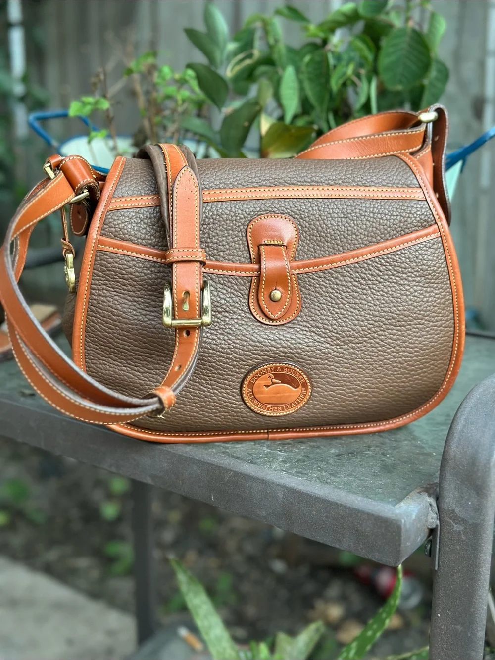Dooney & Bourke Brown Pebbled Leather Horseshoe Crossbody with Tan Trim